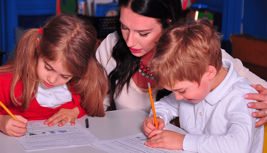 teacher encouraging very young students