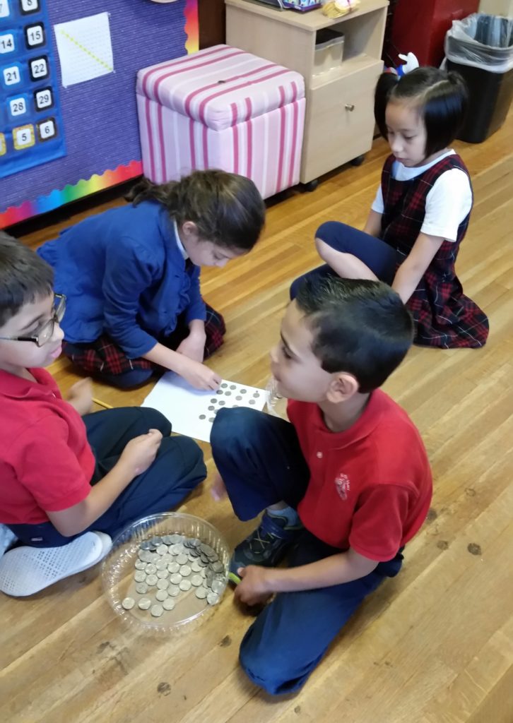 kirby hall second grade students counting donated coins