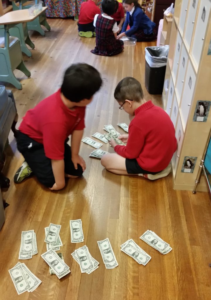 McInerney_kids_counting_bills 2 Kirby Hall 2nd graders counting raised money