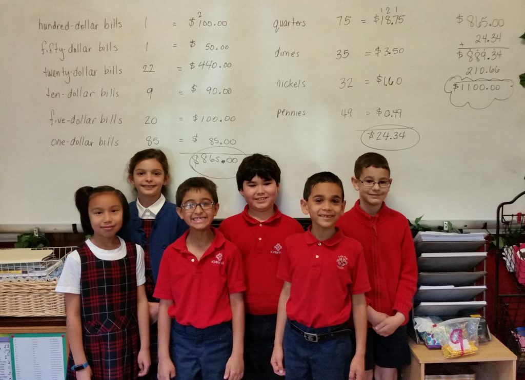 McInerney_kids_with_money_equations 2 2nd grade class standing in front of budget equations